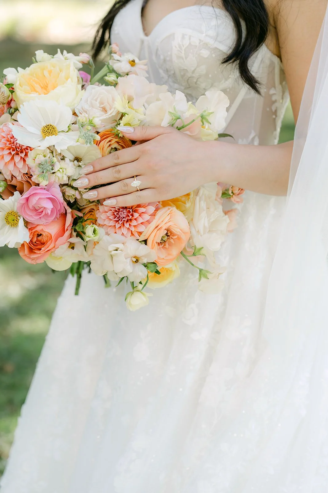 Clarissa's peach and blush bouquet against her gown