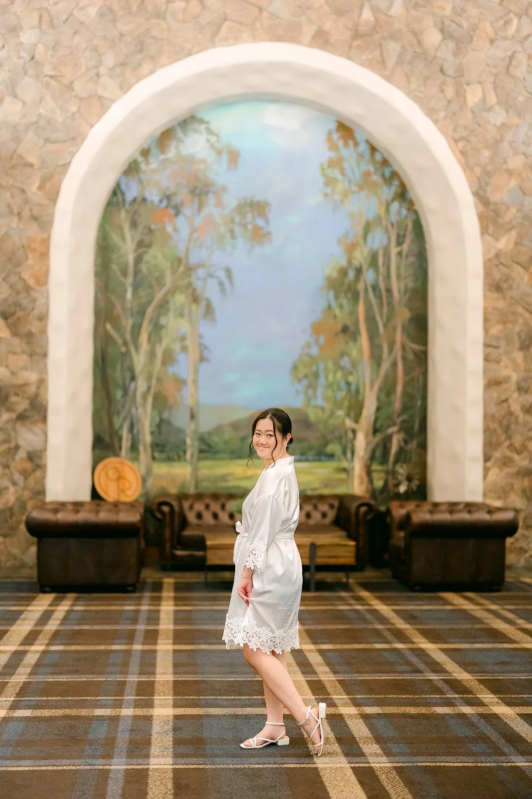 Jessica twirling in her robe under the painted arch