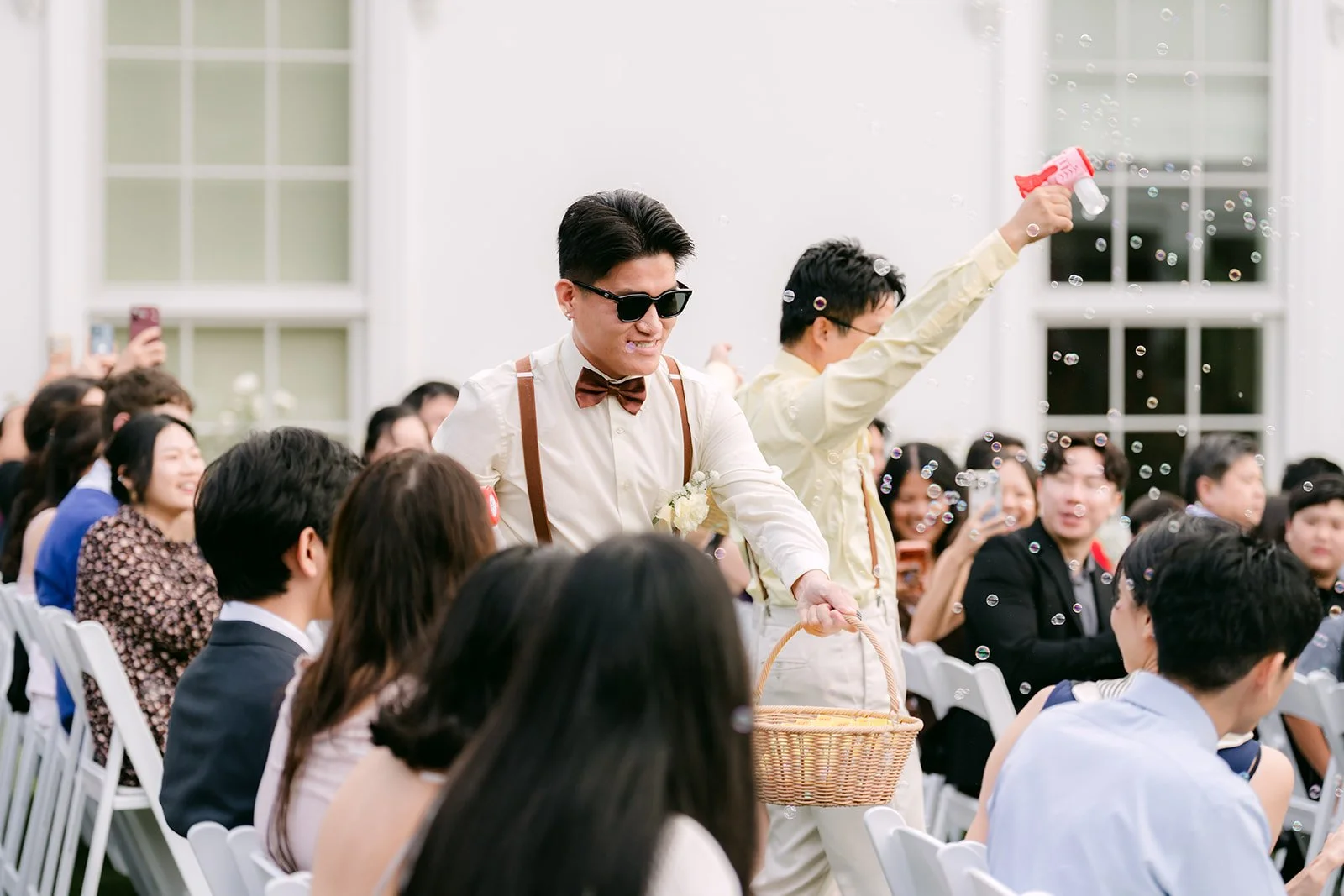 The beer boy making his way down the aisle as guests laugh.