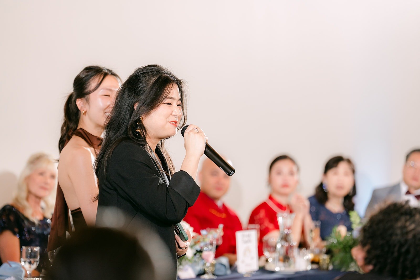 A guest gives a toast as the head table listens