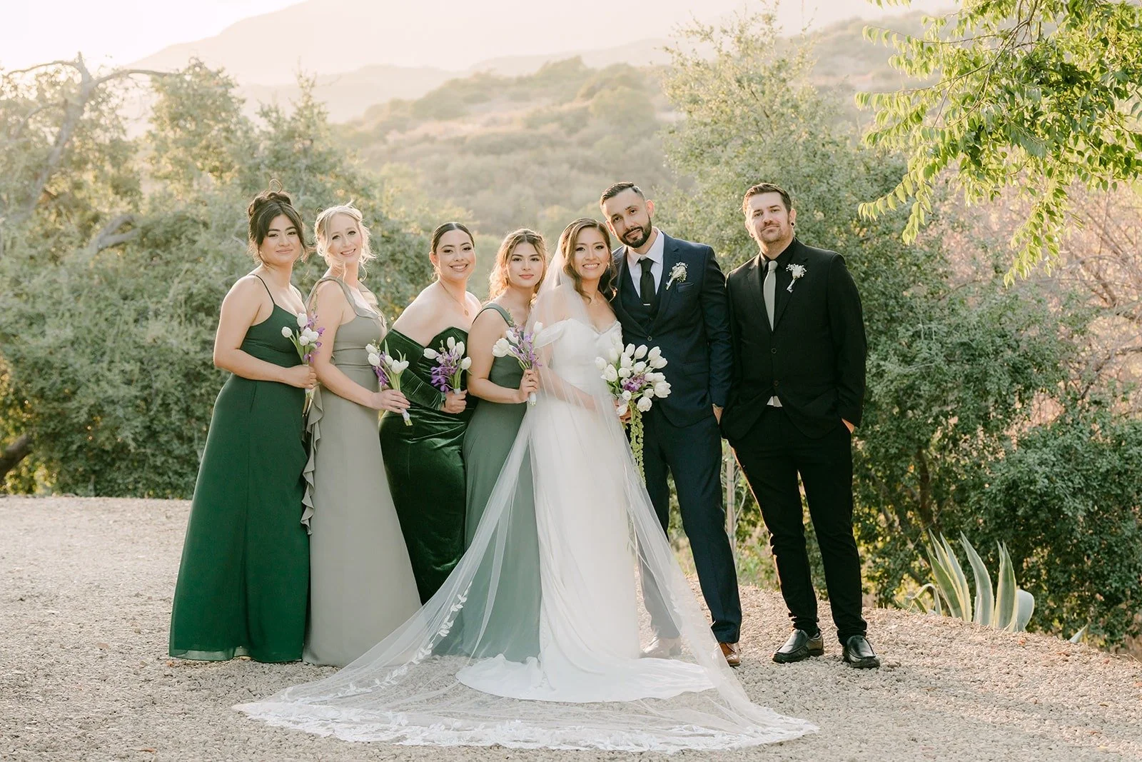 Mariana and Danny with their wedding party on the hilltop at Padua Hills Theatre