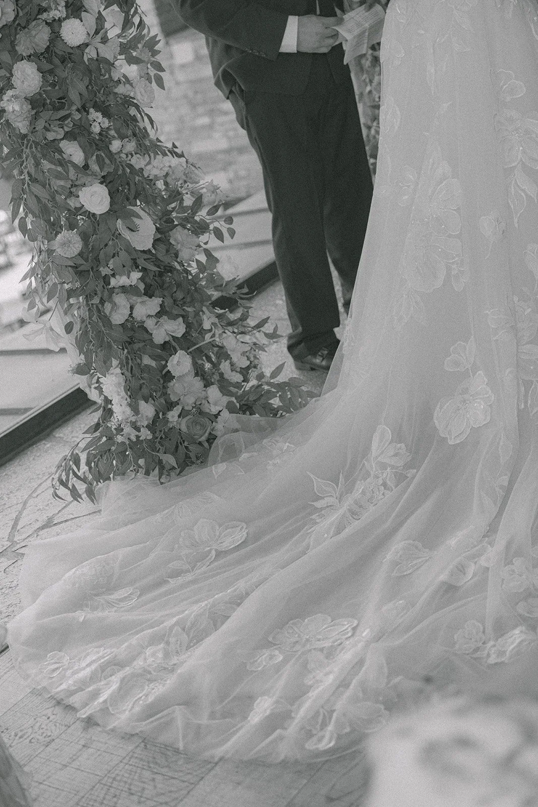 A black and white detail of Mary's gown at the altar
