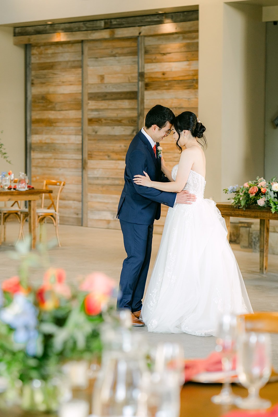 Couple sharing a kiss inside the reception hall