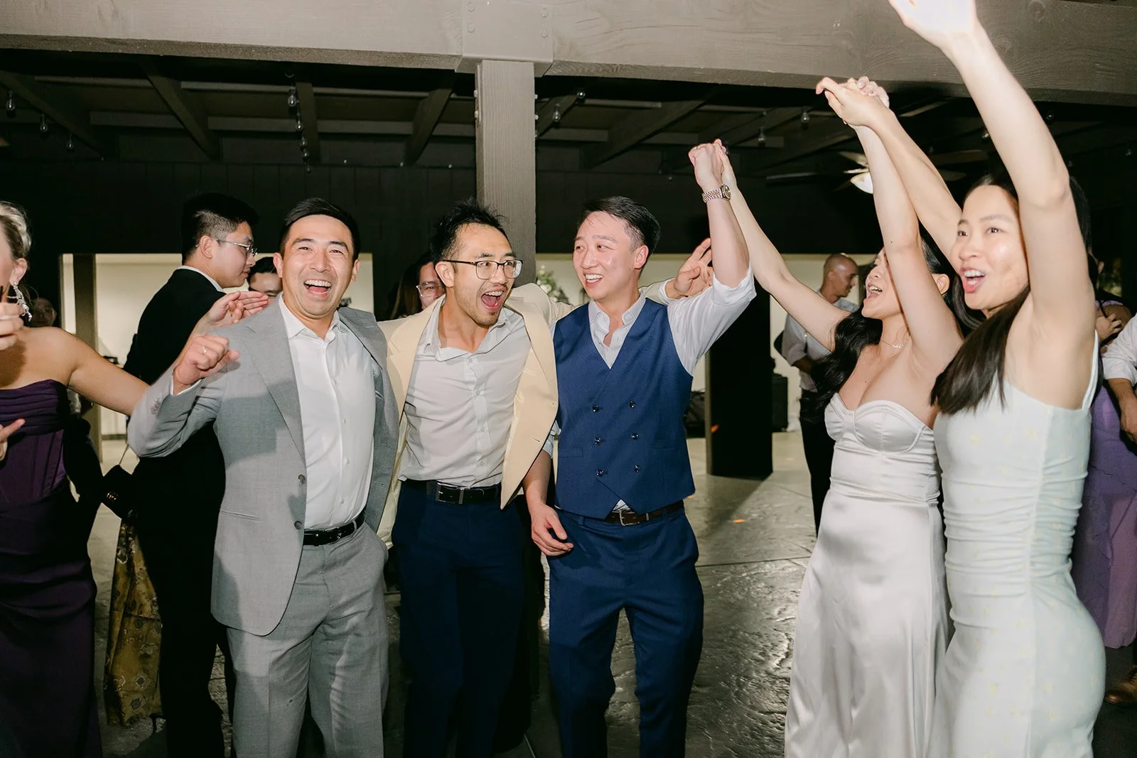 Guests dancing with their arms in the air.