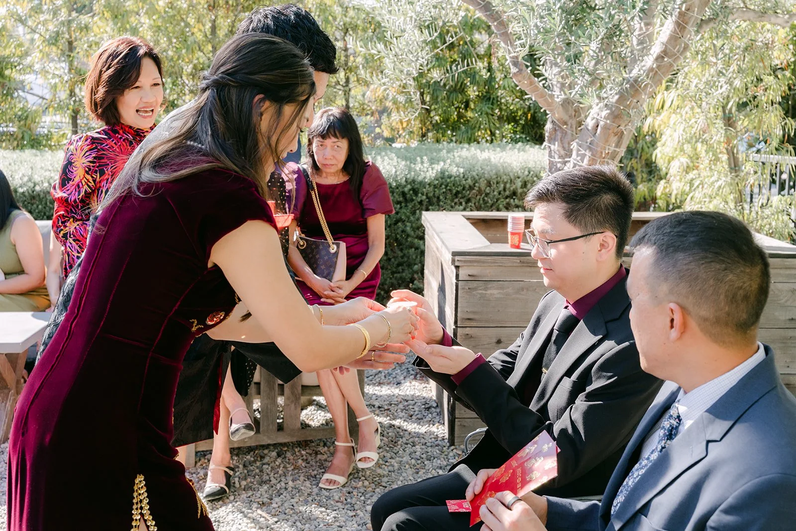 Tea ceremony in the garden with family seated