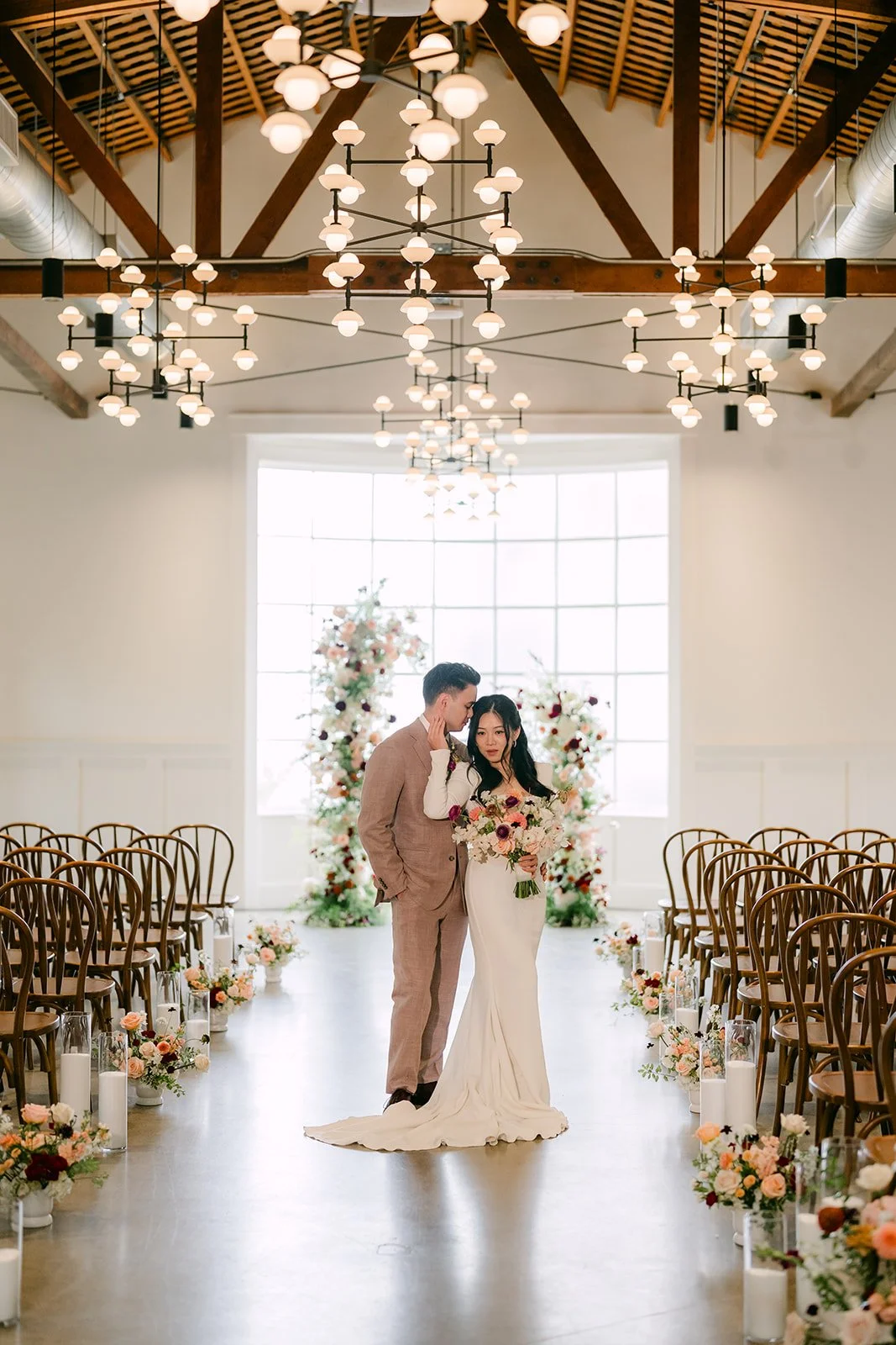 Denise and Michael at the altar at the end of the aisle in the ballroom.