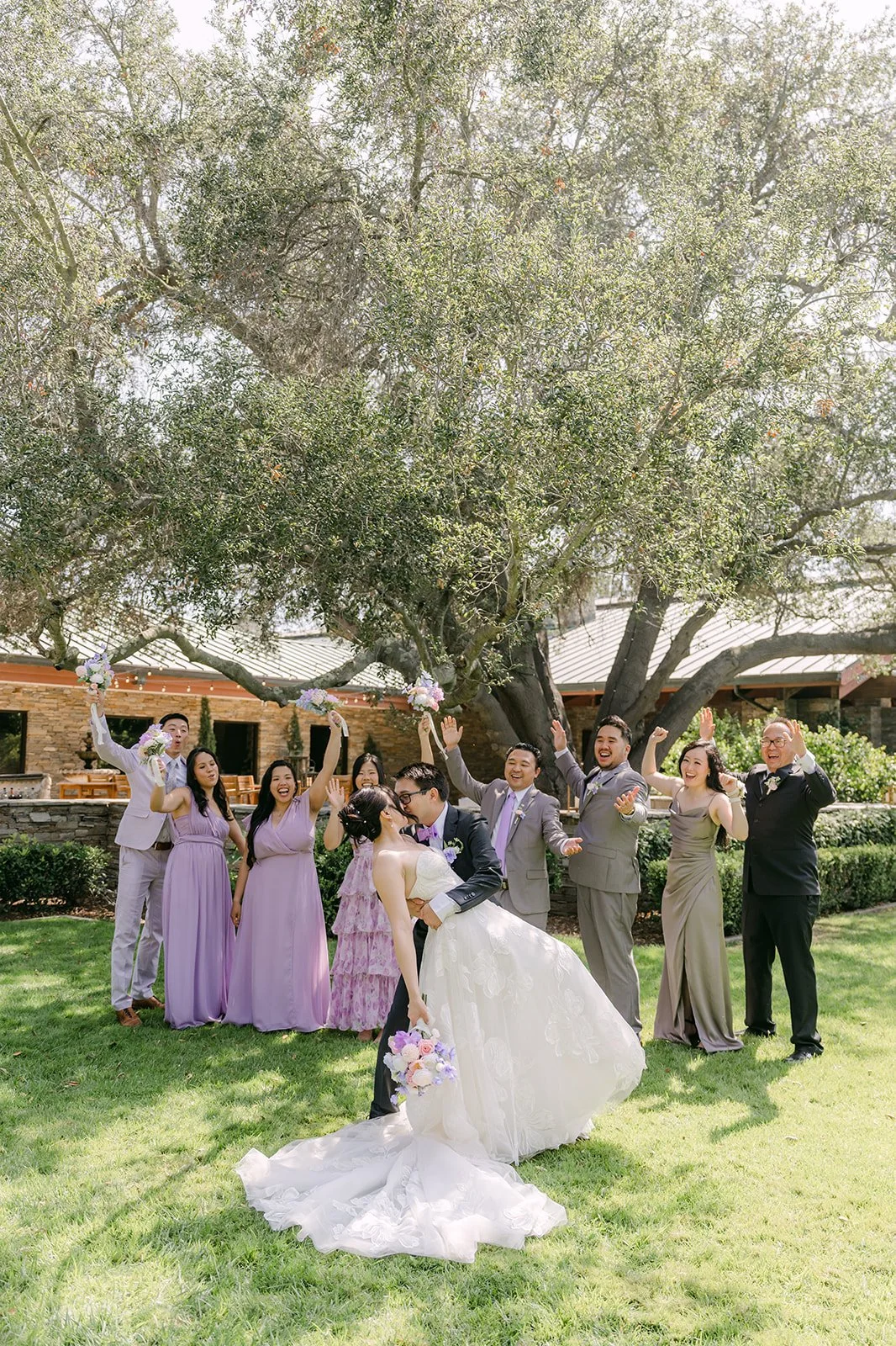 The wedding party celebrating on the lawn