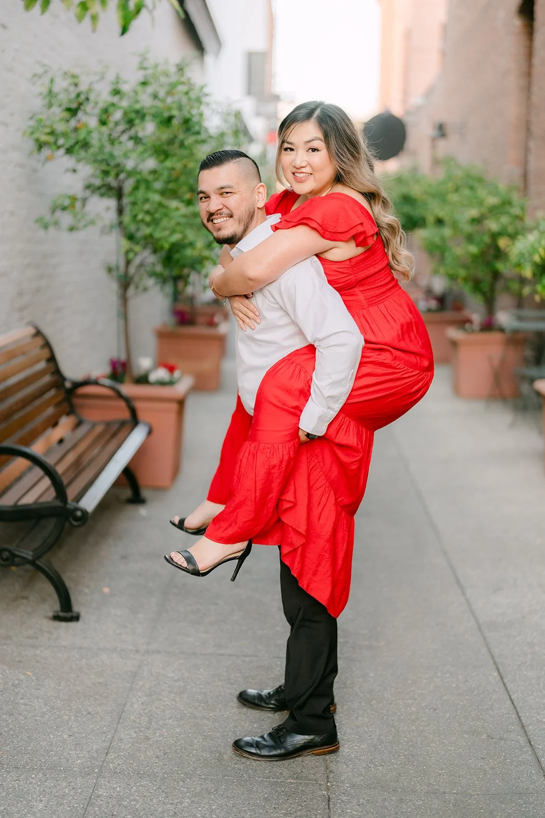 Ankush lifts Linh off the ground as she kicks up her heel.