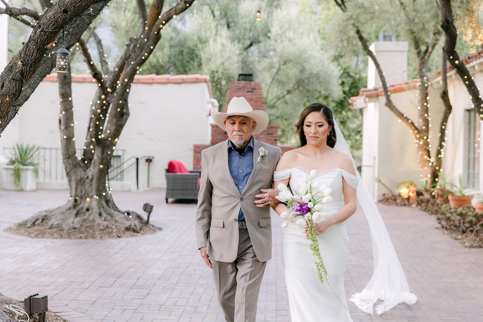 Mariana walking toward the ceremony with a family member