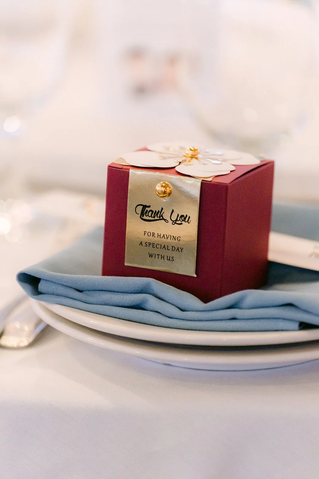 Red favor box on a dusty blue napkin