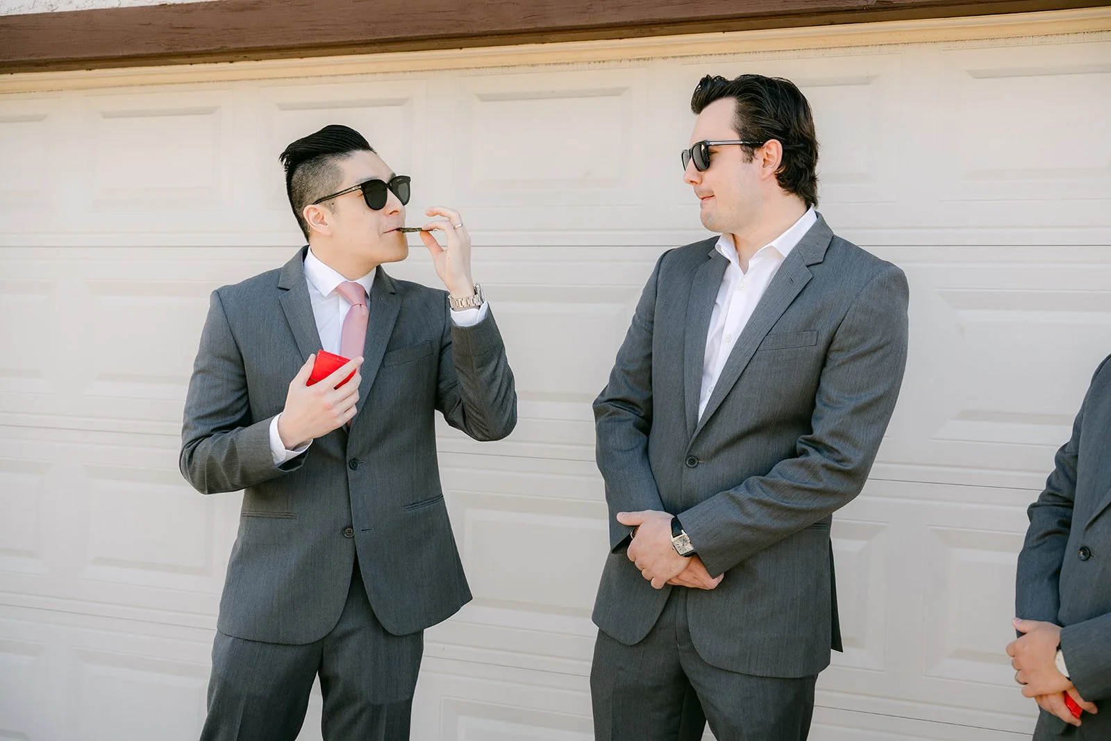 Groomsmen in sunglasses waiting for the next challenge.