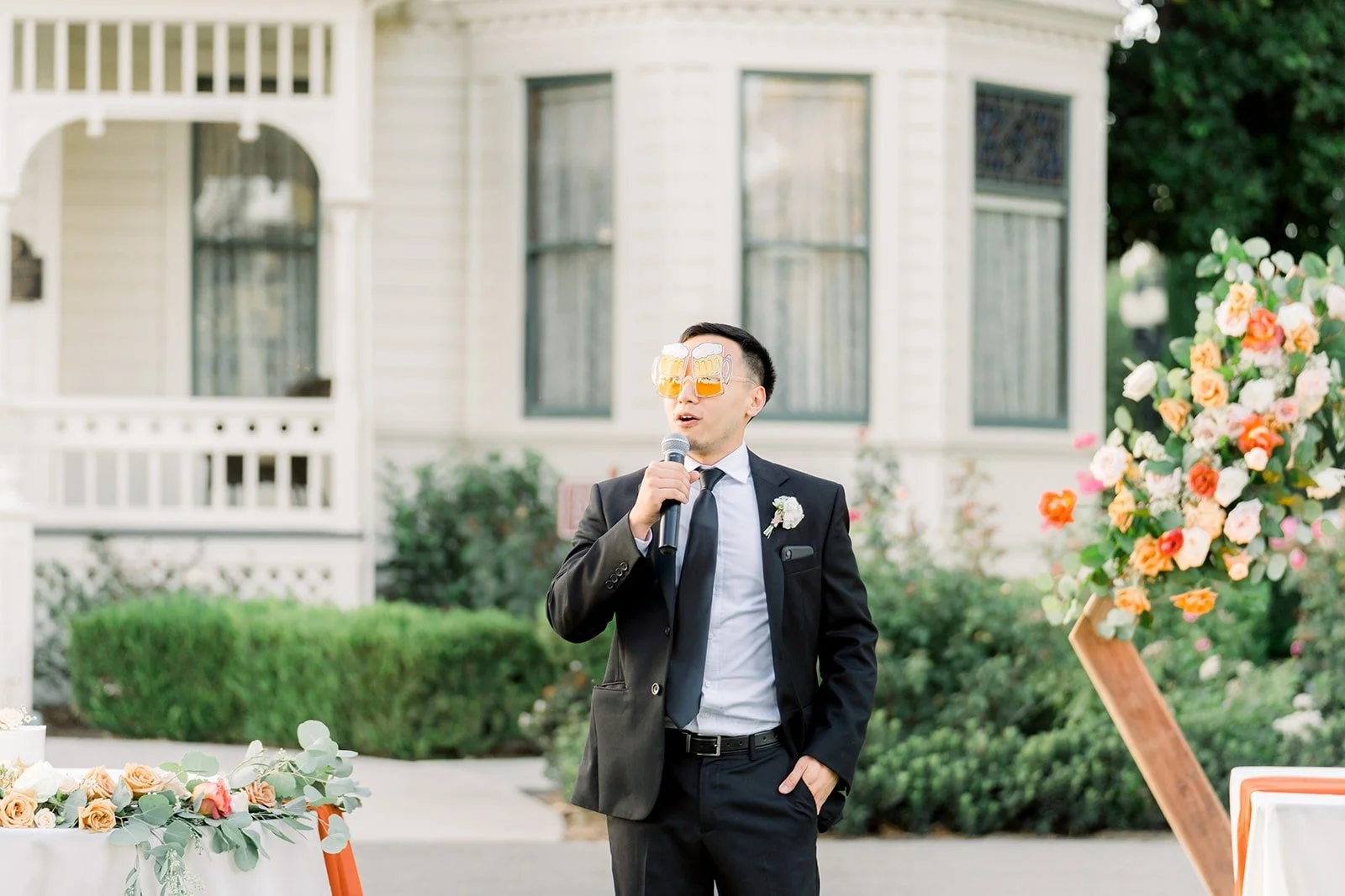 A groomsman giving a speech in front of the ranch house