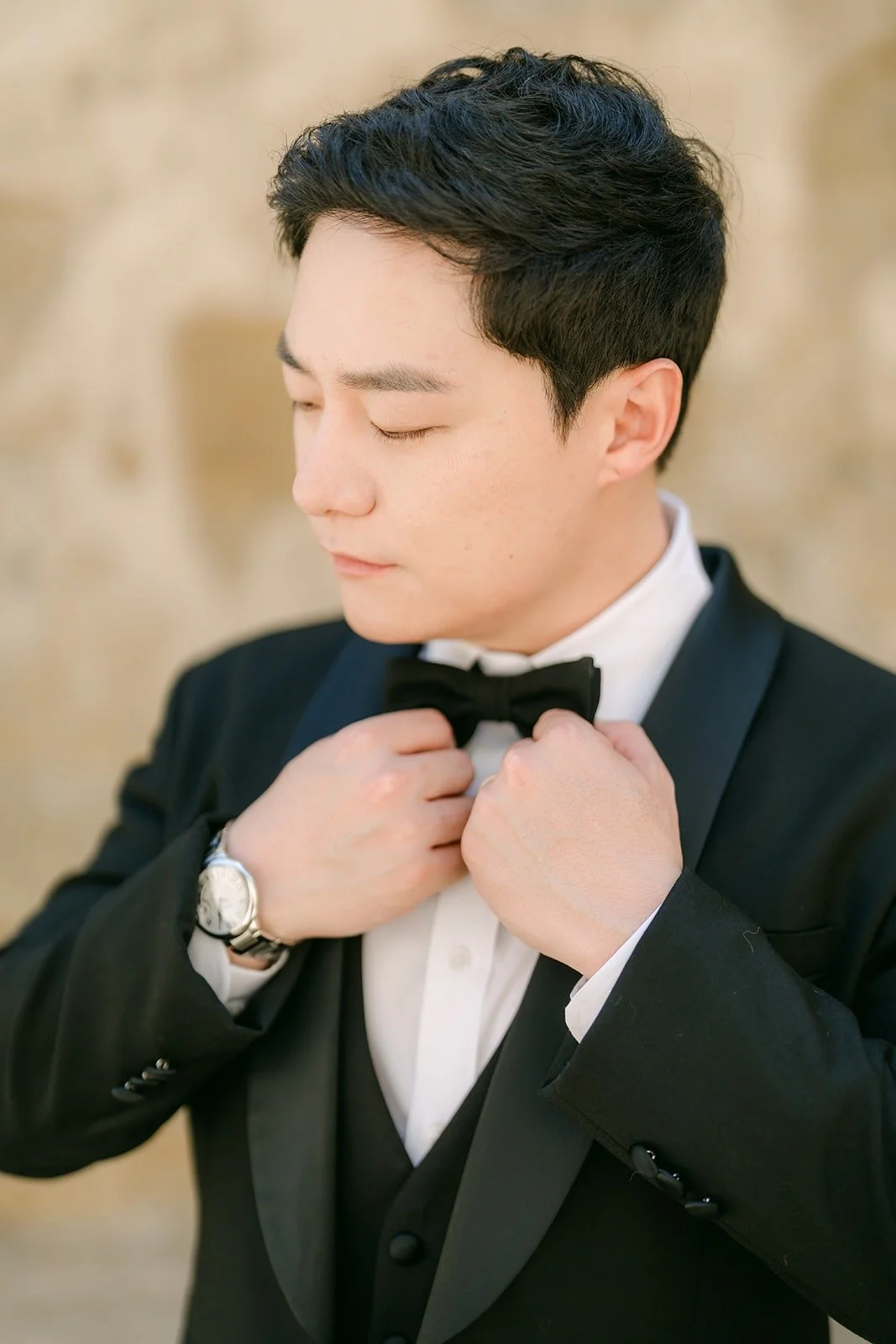 Min Soo straightening his black bow tie