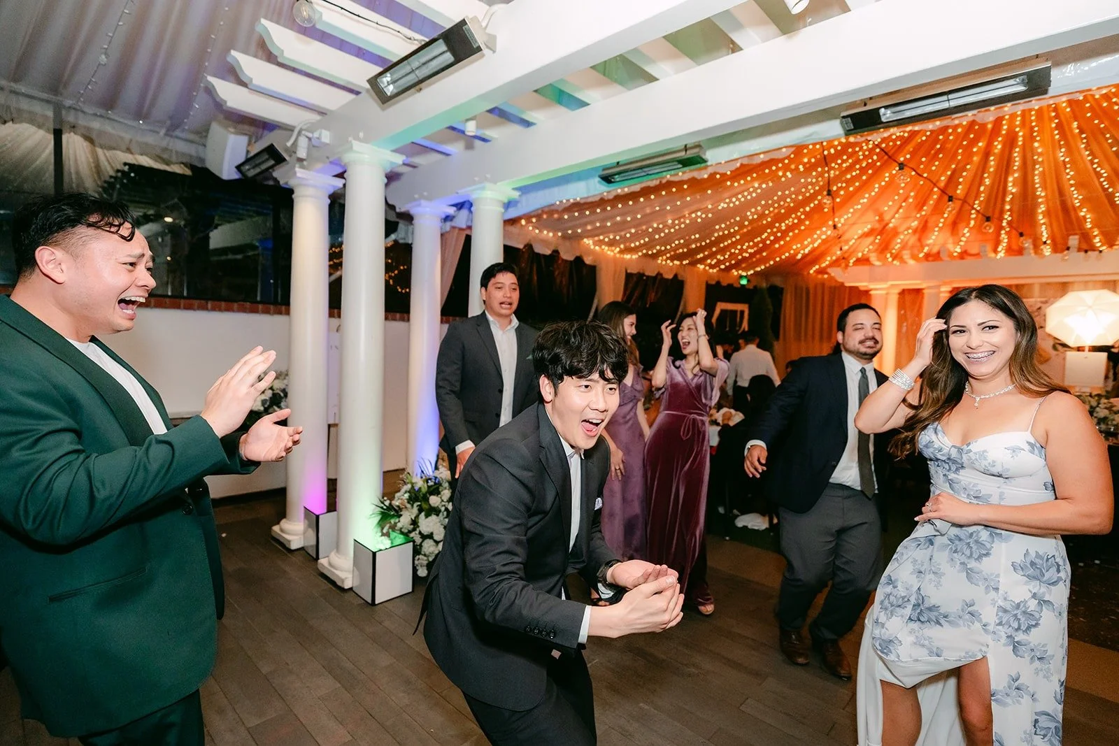 Guests dancing under the string lights
