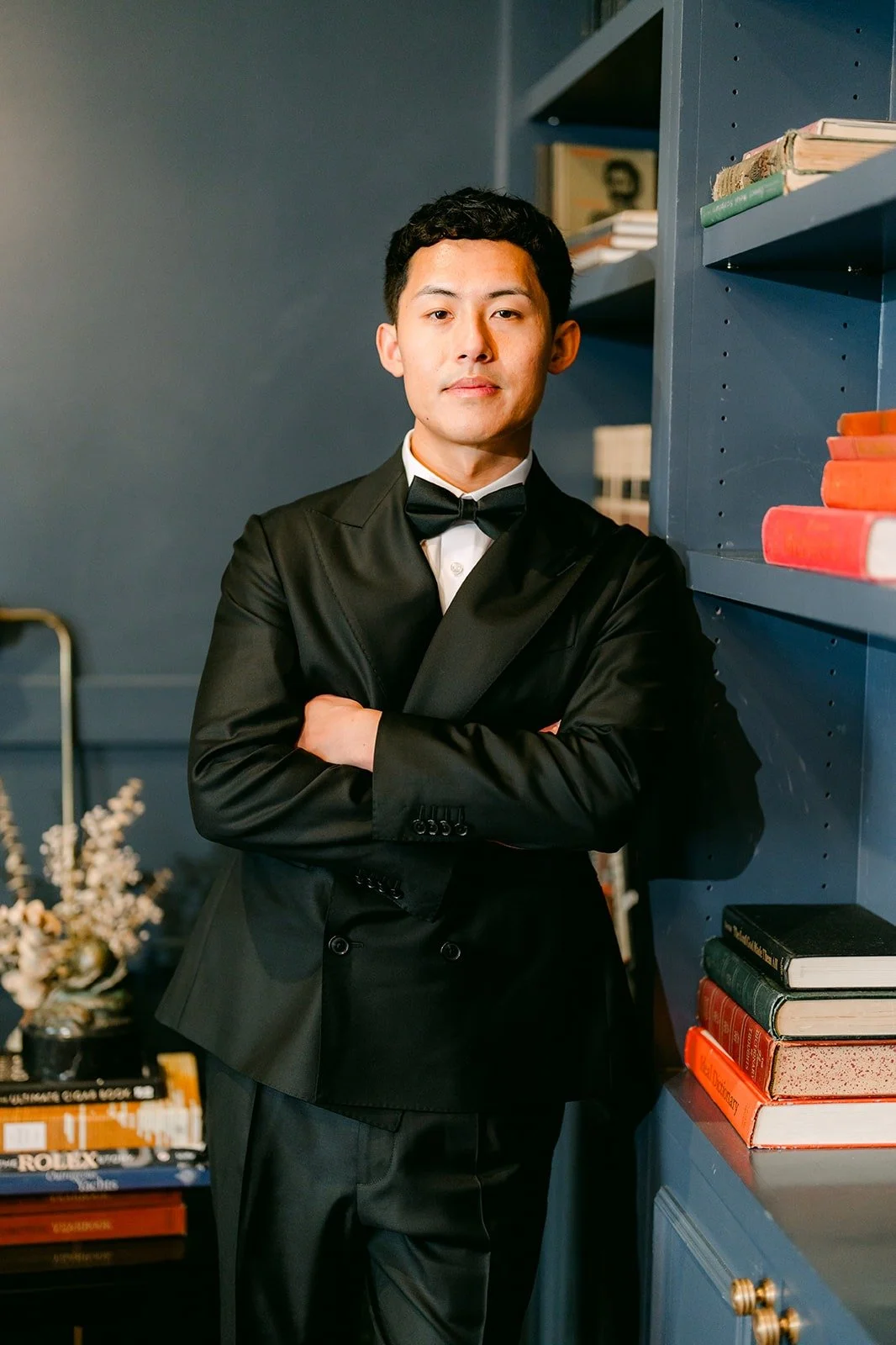 Richard in his tuxedo by the bookshelves at The Harper