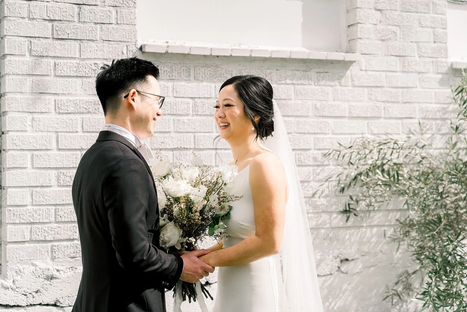 Cindy and Alex smile at each other during the first look