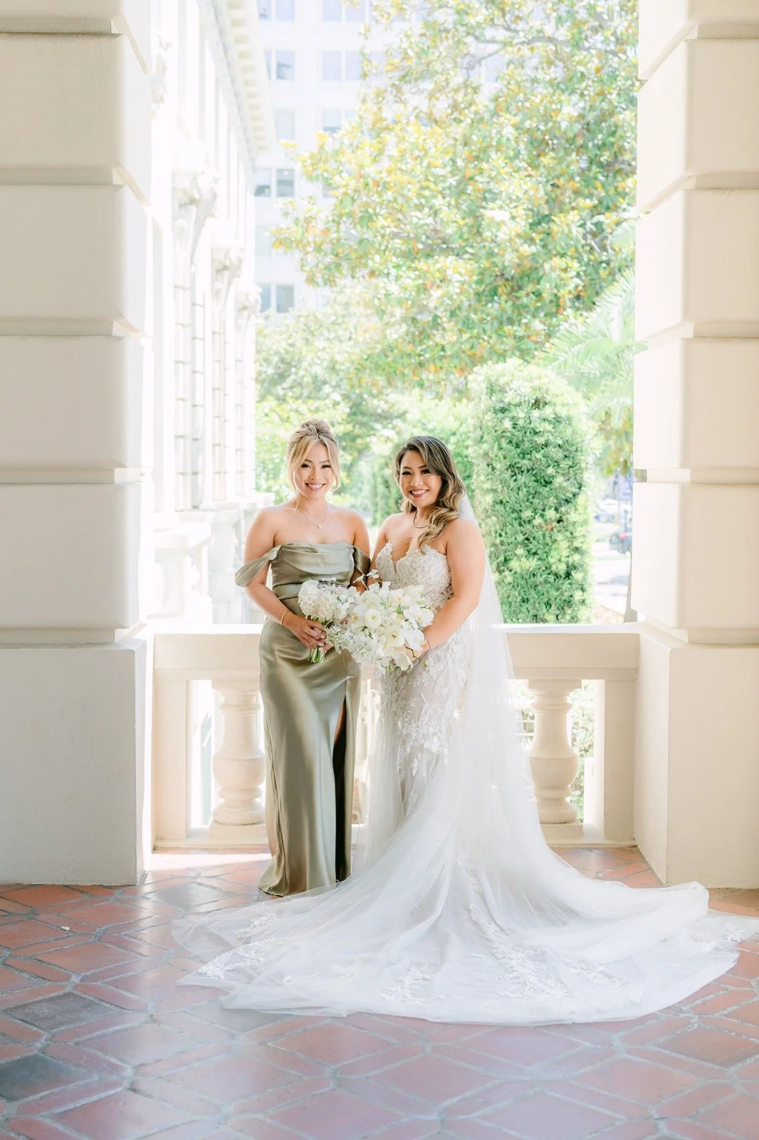 Candice with her maid of honor Brittnie under the arches