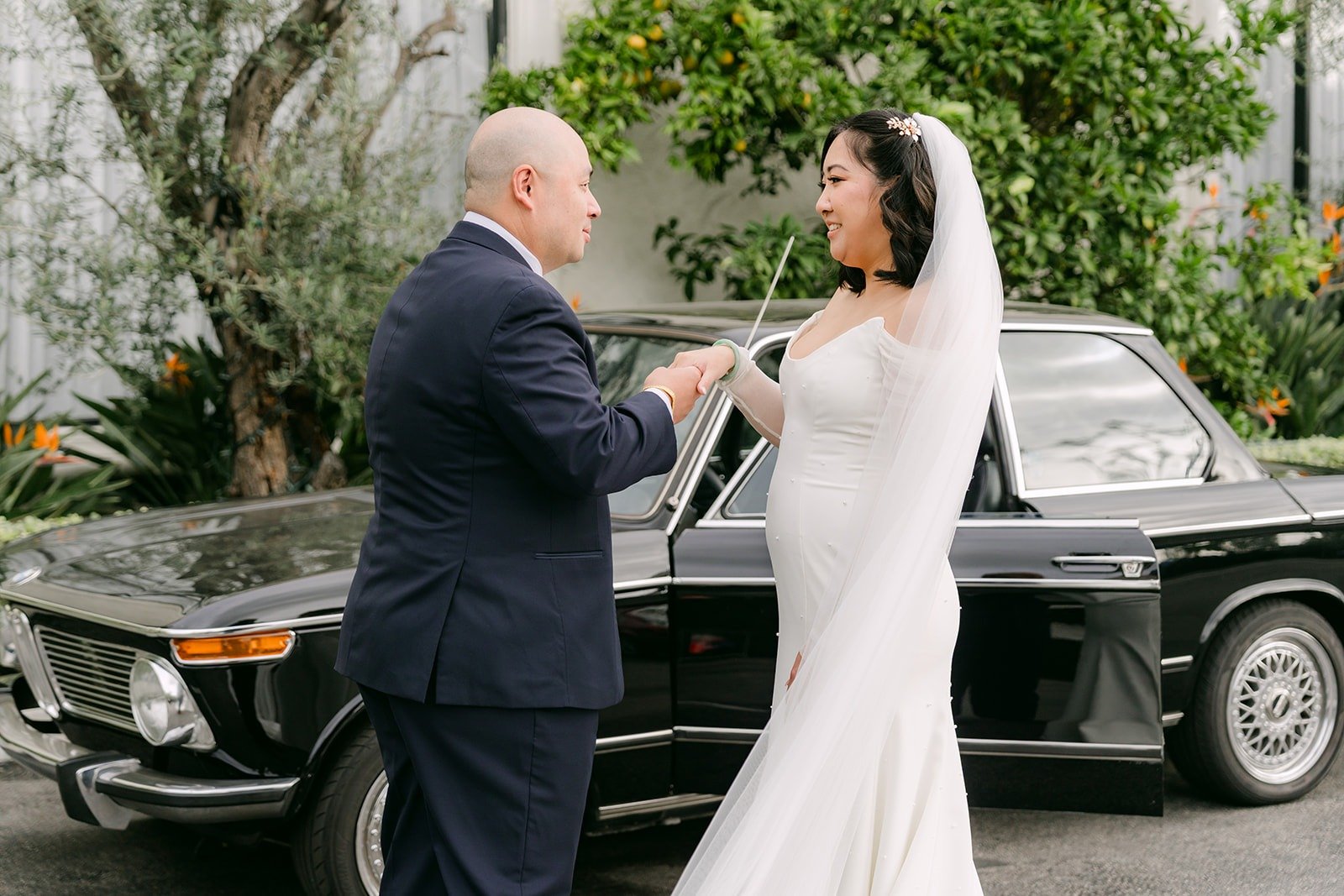 Yao spinning Vivian next to the vintage car, photographed by One and Only Production