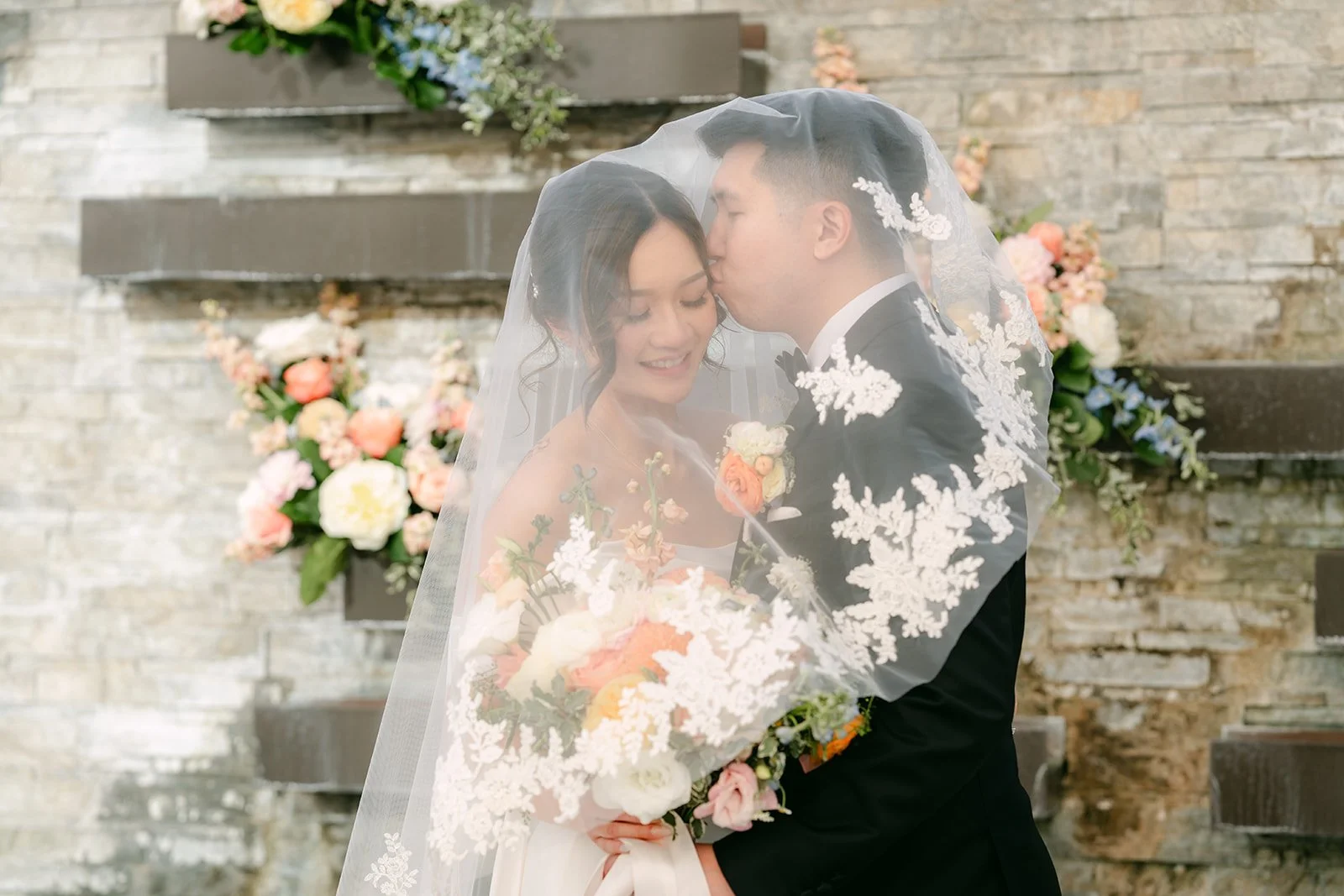 Amanda and San sharing a quiet moment under the veil at Courtyard Monterey Park, photographed by One and Only Production.