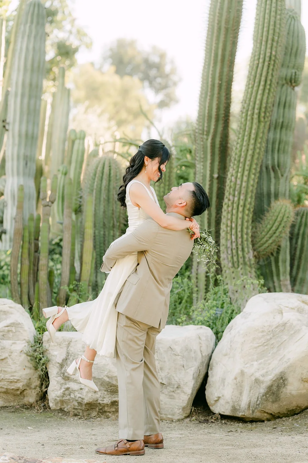 Vincent lifts Kim off the ground in the cactus garden.