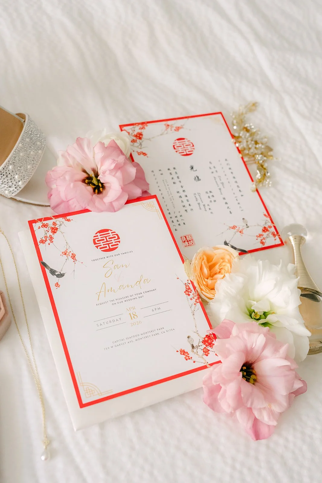 Amanda and San's wedding invitation suite with pink roses and a red border.