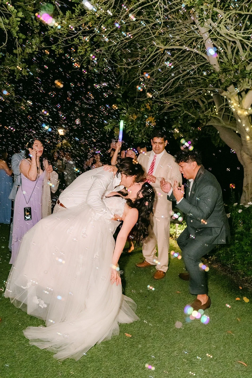 Mike dipping Kat for a kiss during the bubble exit
