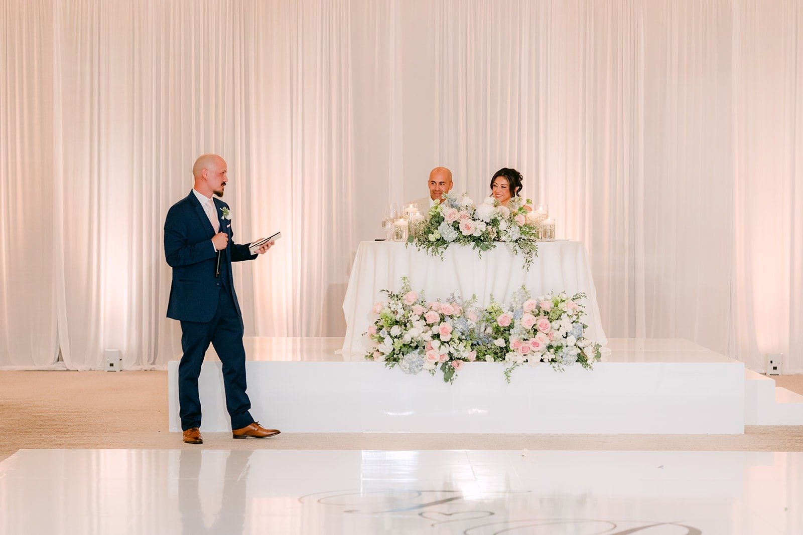 A groomsman gives his speech to the couple