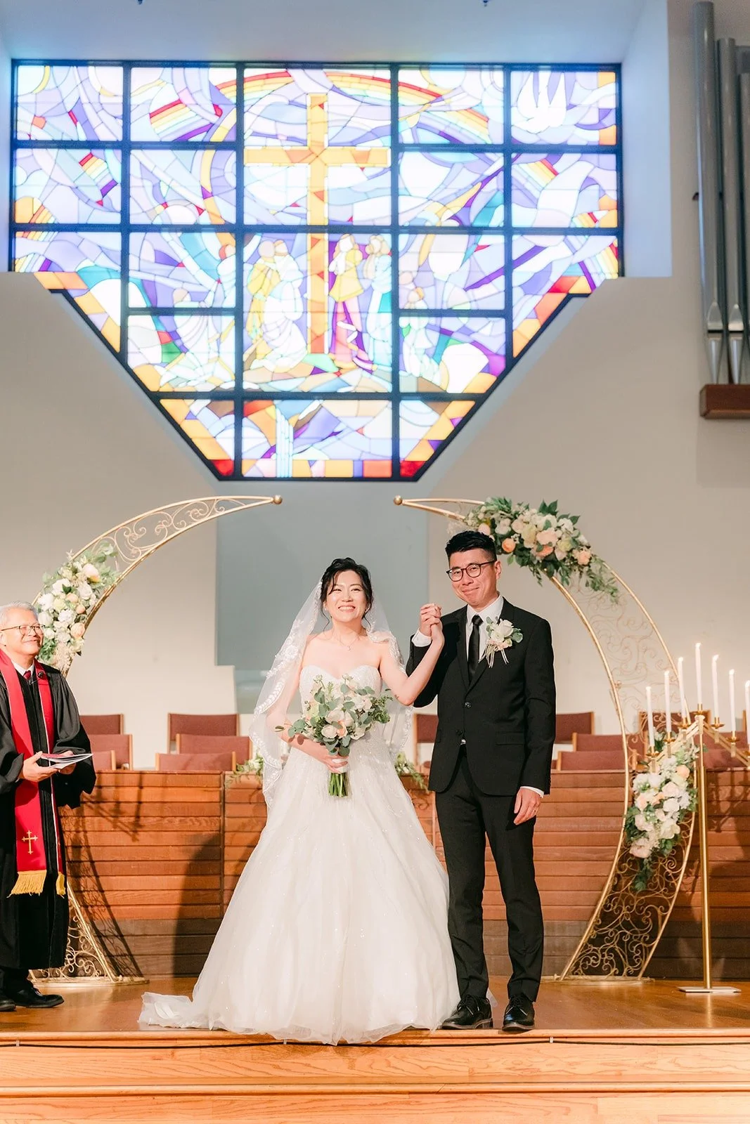 Eunice and Eric at the altar under the stained glass window at Mandarin Baptist Church of Los Angeles