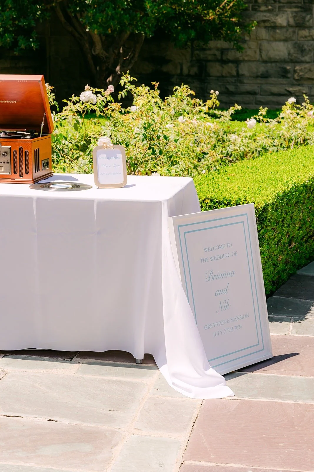 Welcome table with a guestbook and vintage record player