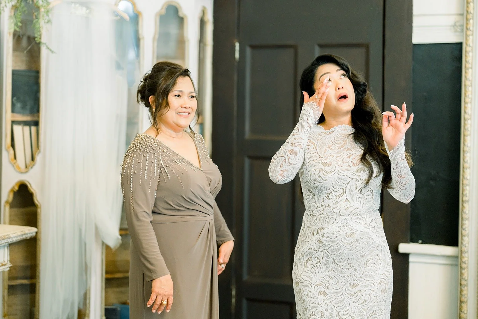 Hannah and her mom laughing during their first look