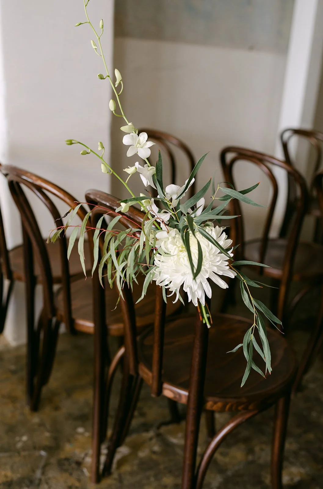 White florals tied to the ceremony chairs