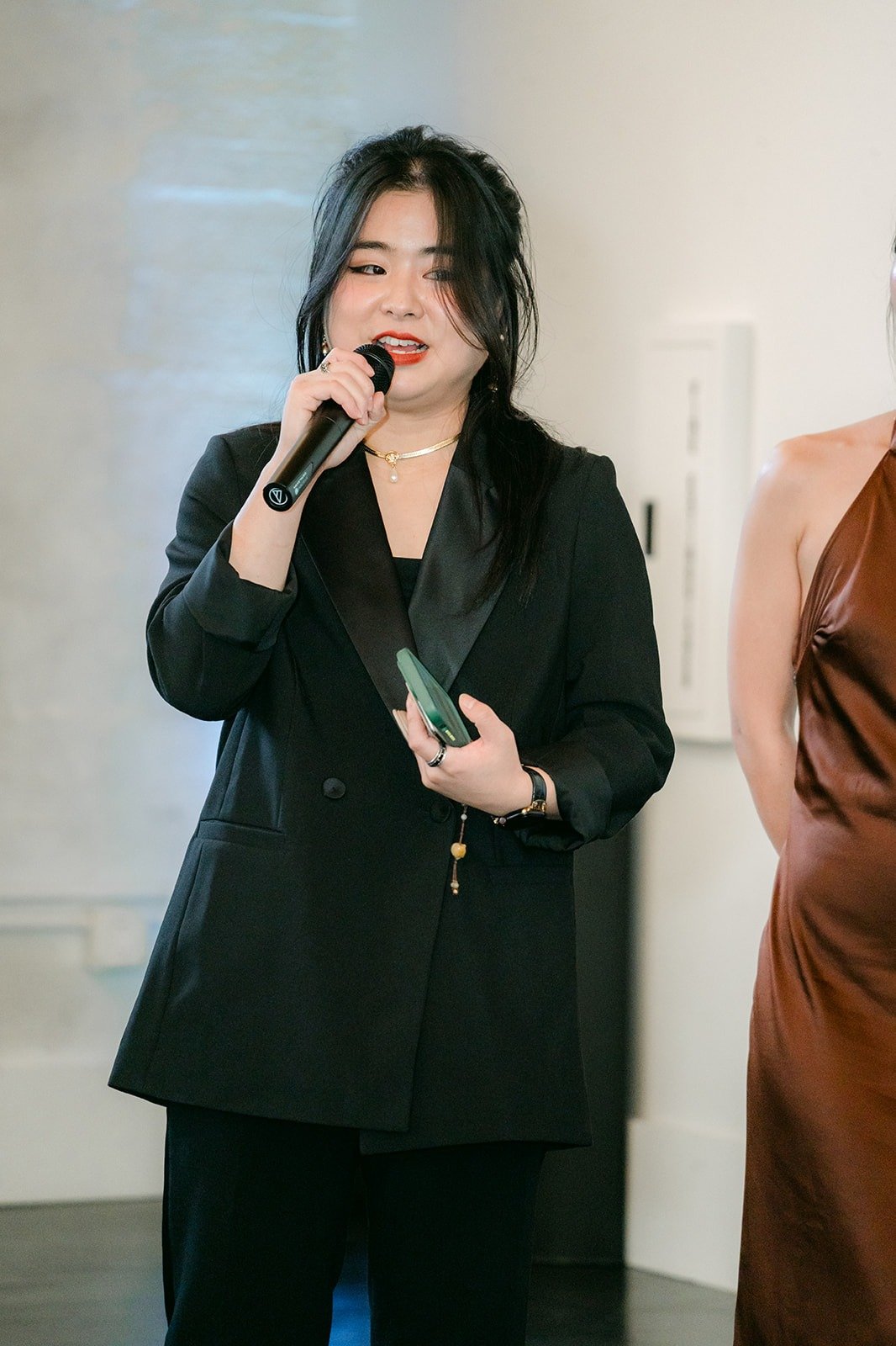 A guest in a black suit gives her toast