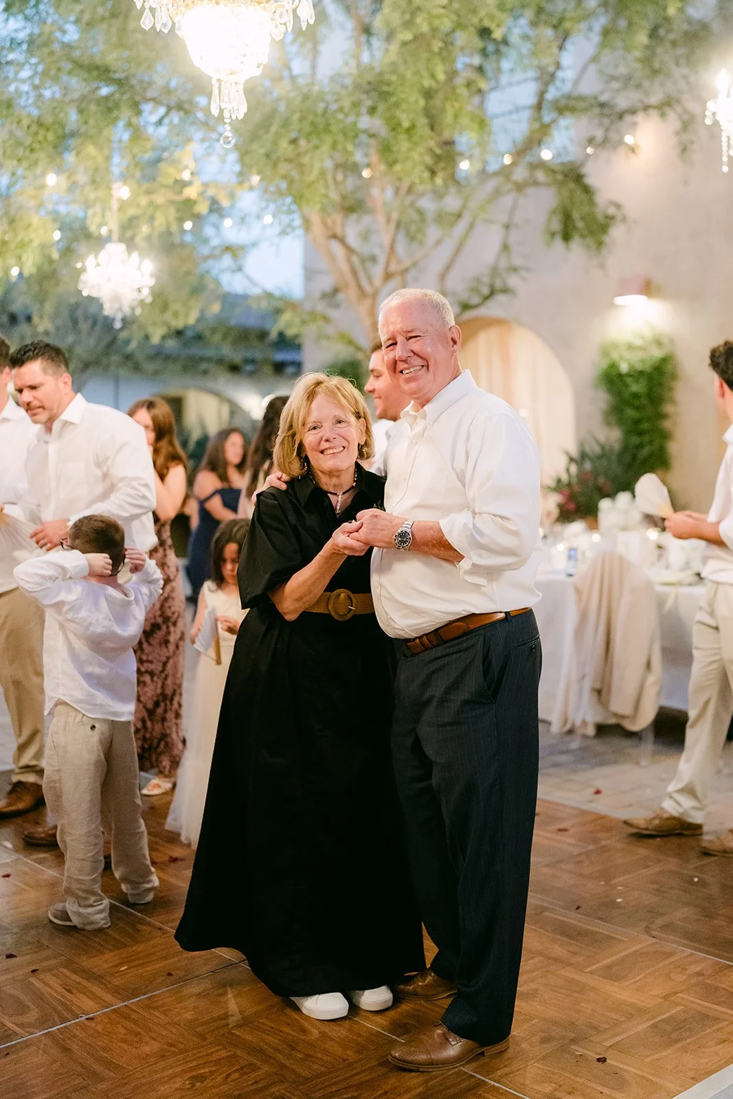 Guests slow dancing together on the courtyard dance floor