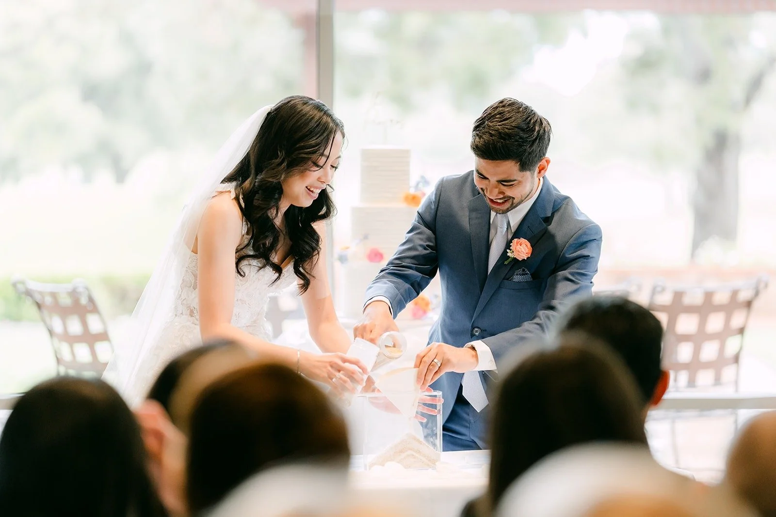 Natalie and Mark pouring their sand together at the ceremony table