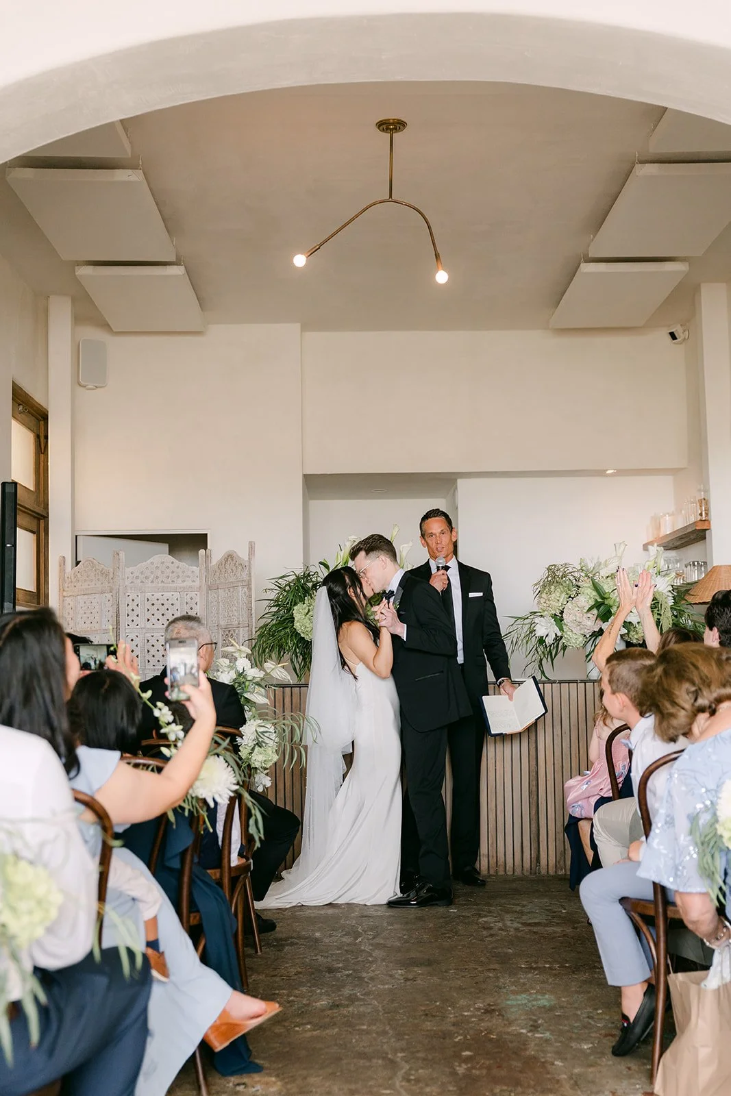 The newlyweds cheering with guests