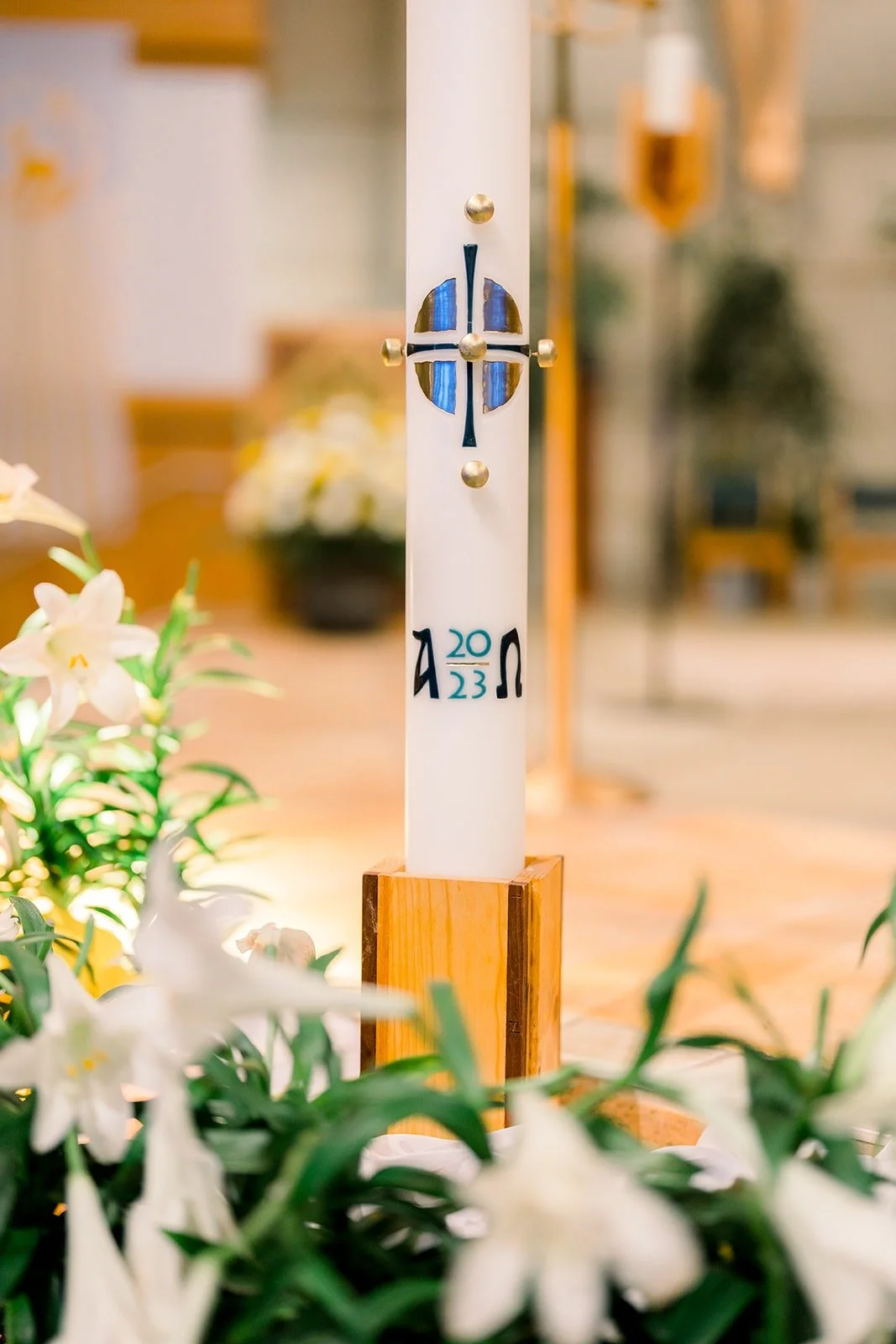 White lilies beside the altar candle at the church