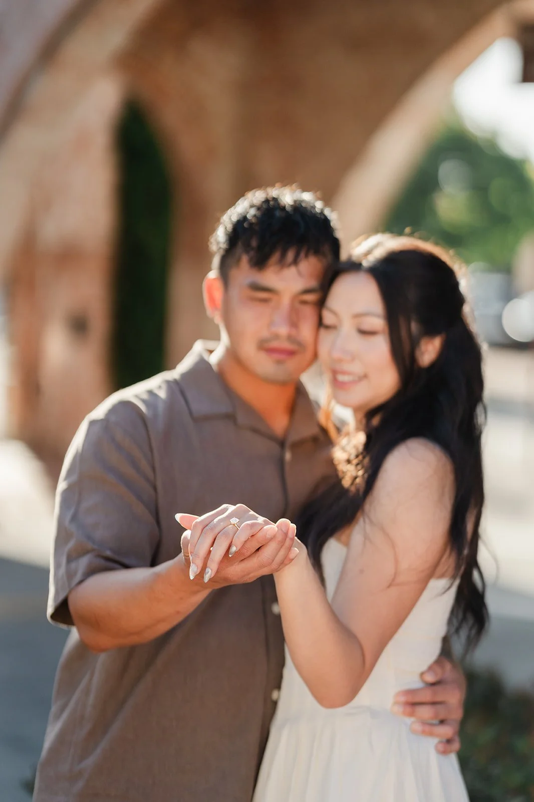 Close-up of Andrew holding Victoria's hand as she smiles.