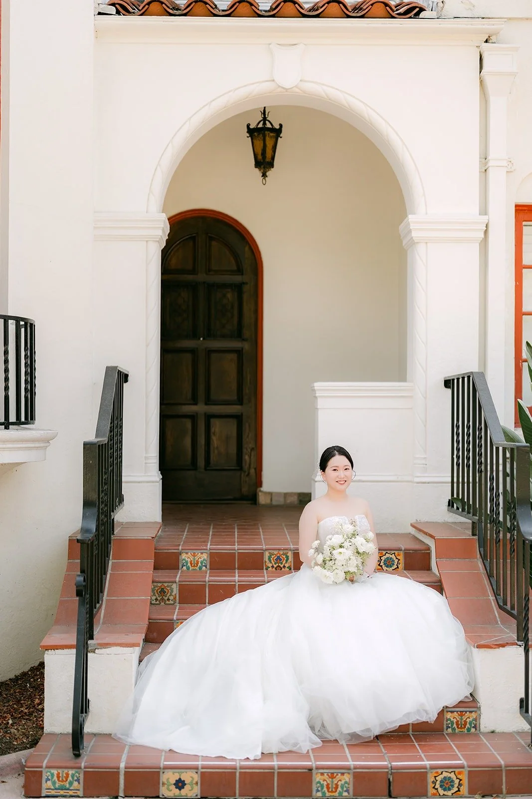 Amy seated on the brick steps of the Muckenthaler mansion
