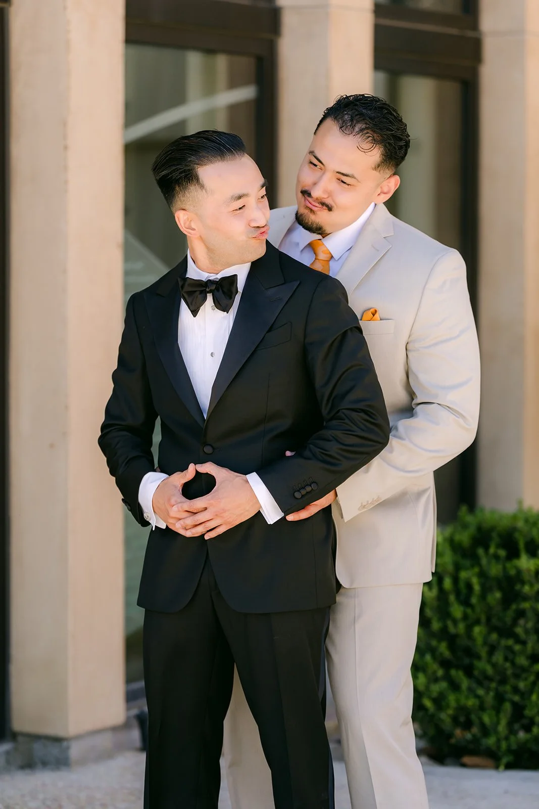 A groomsman helping Vincent with his boutonniere