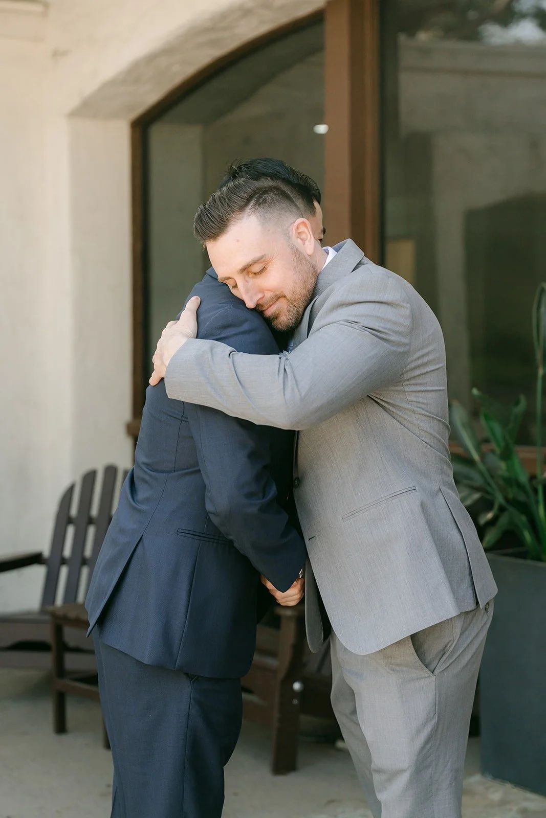 Jordan hugging a groomsman before the ceremony