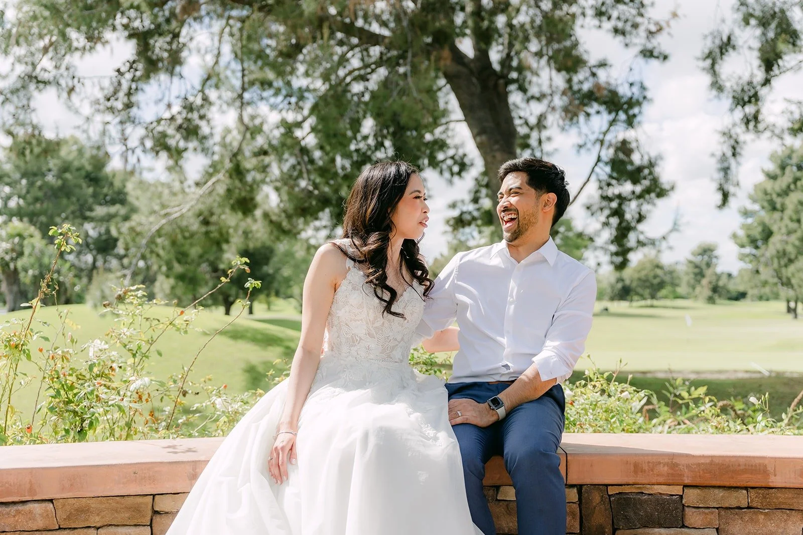 Mark gazing at Natalie as they sit on the wall above the fairway