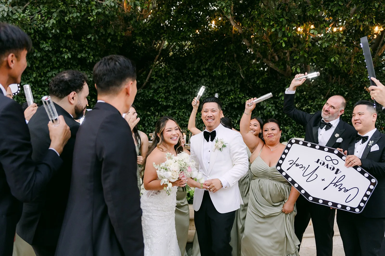 Nicole and Caryl entering the reception with their wedding party bottle service style.