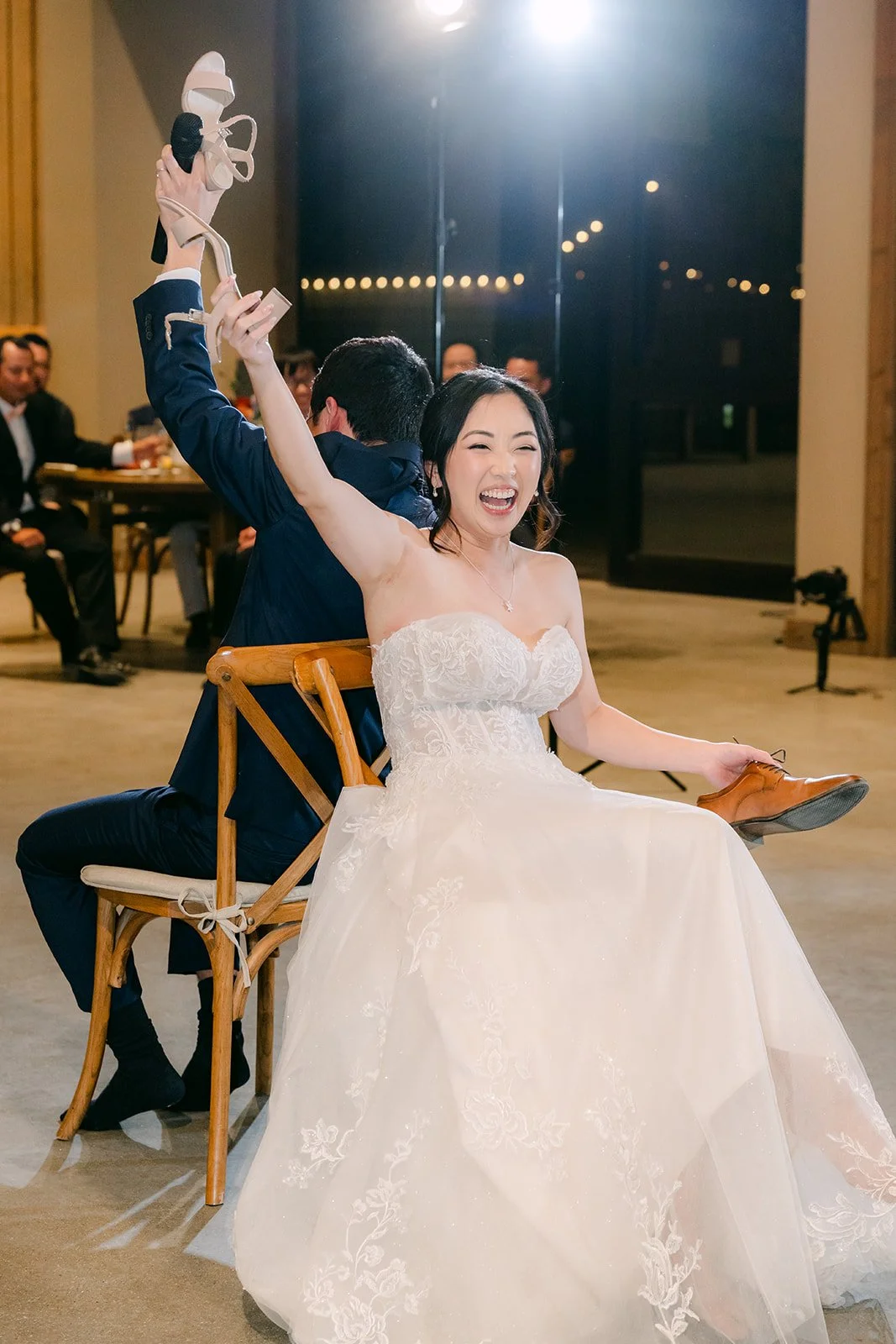 Bride raising a shoe during the shoe game