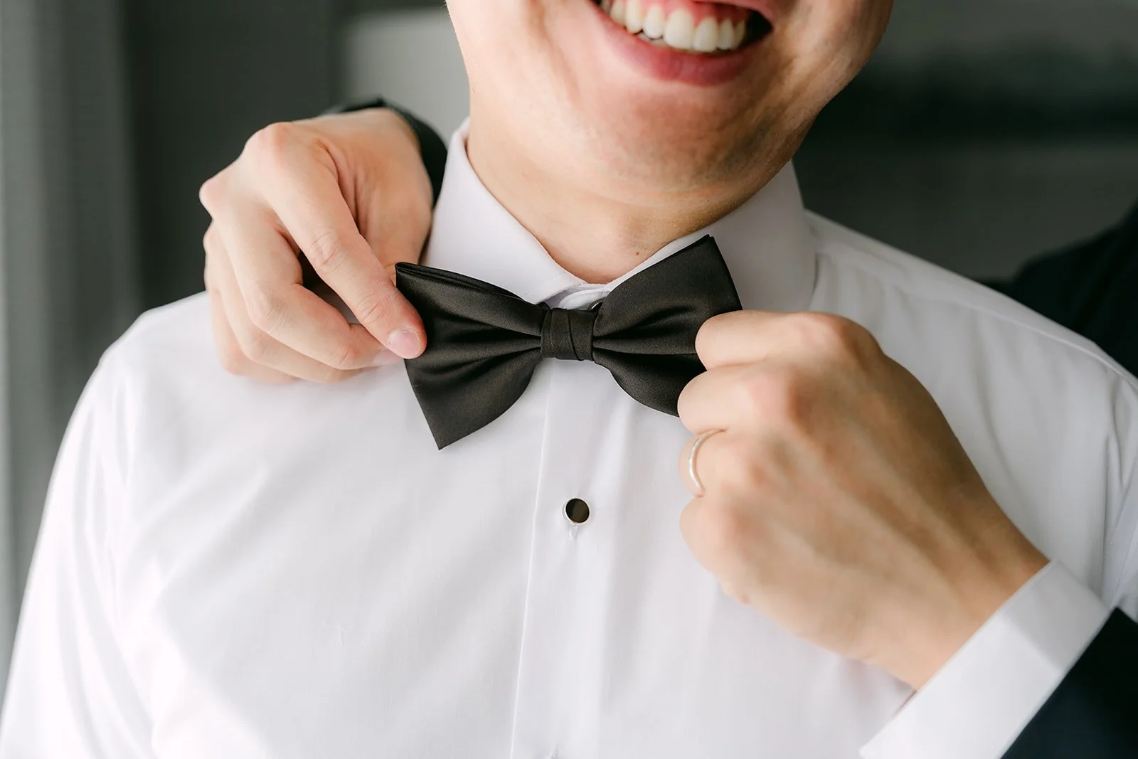 San adjusting his bow tie.