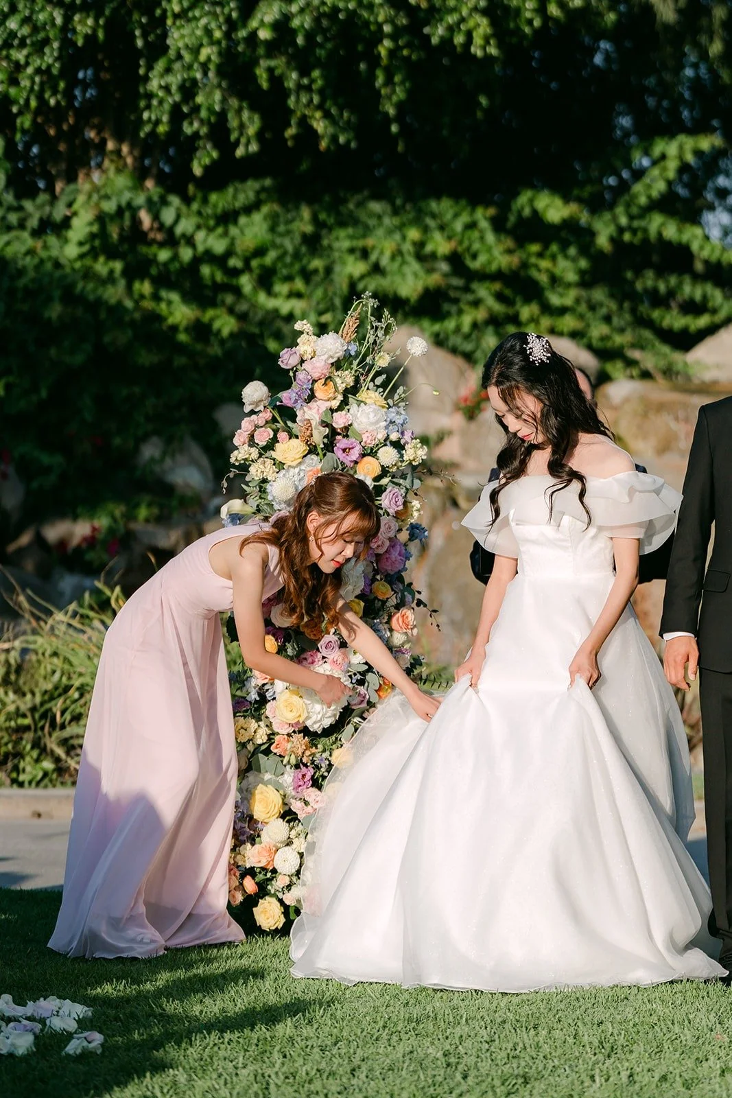 Stephanie adjusting Jeannie's gown at the floral columns