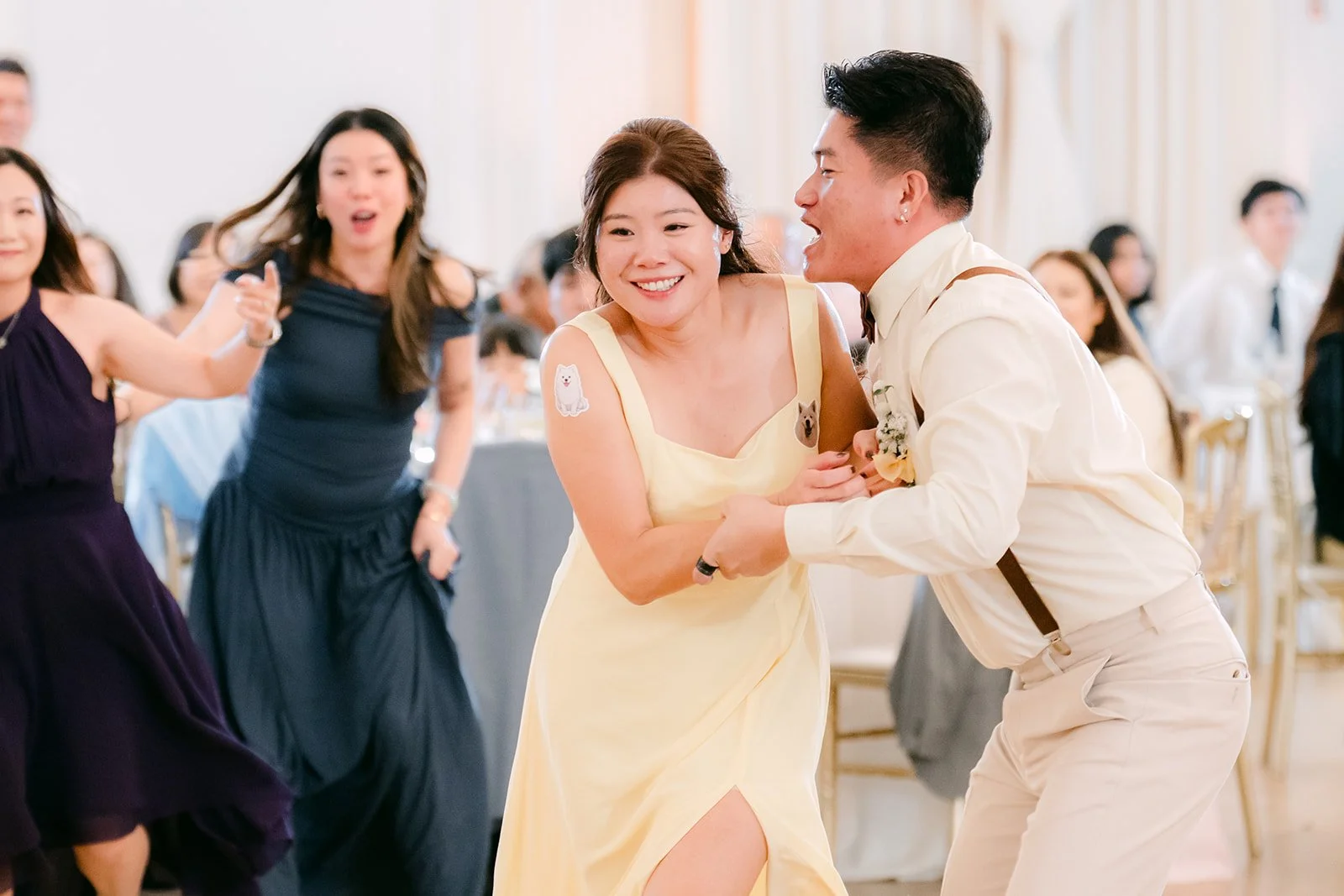Guests laughing and dancing during the reception games.