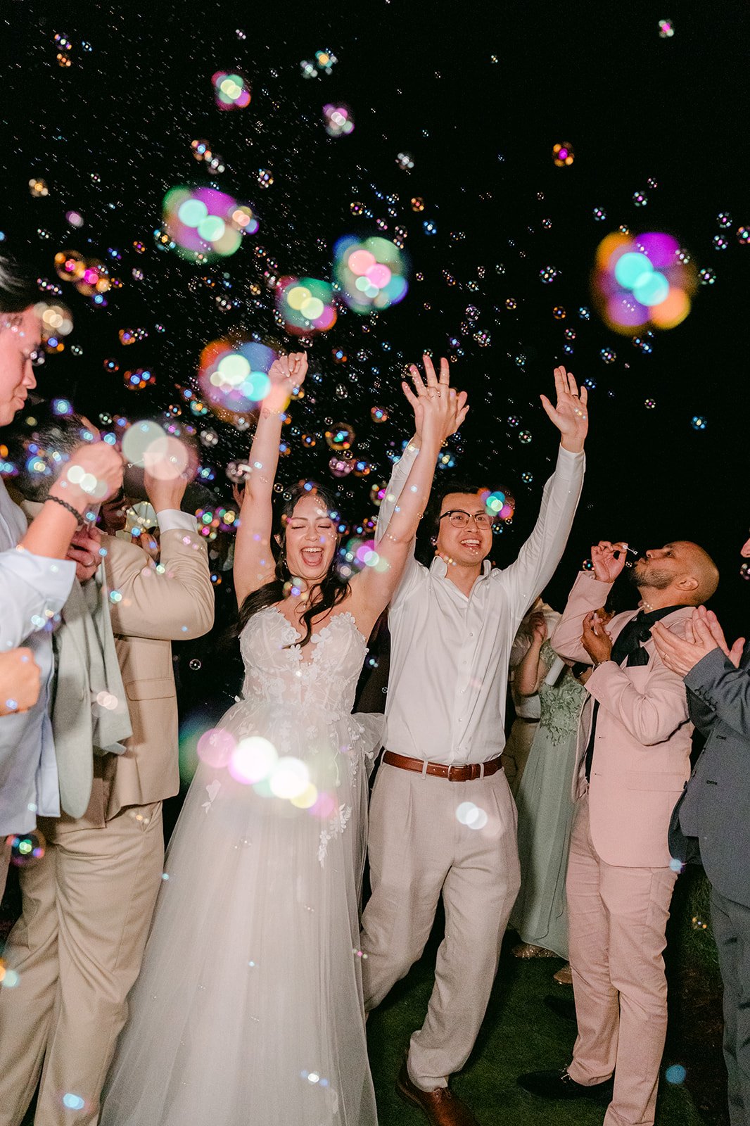 Bubble exit at night with guests cheering for Kat and Mike