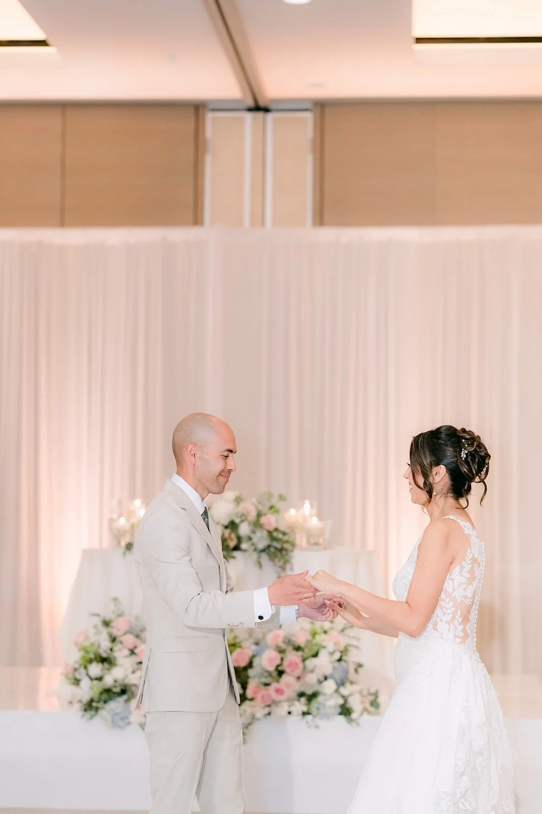 Daniel in his ivory suit takes Francesca's hand