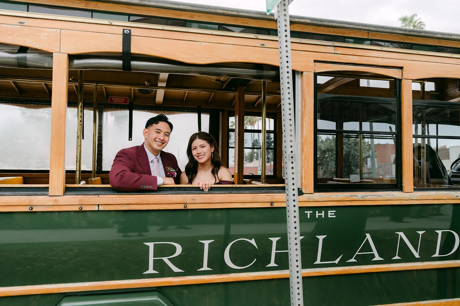 Guests smiling in the trolley with The Richland lettering on the side, photographed by One and Only Production.