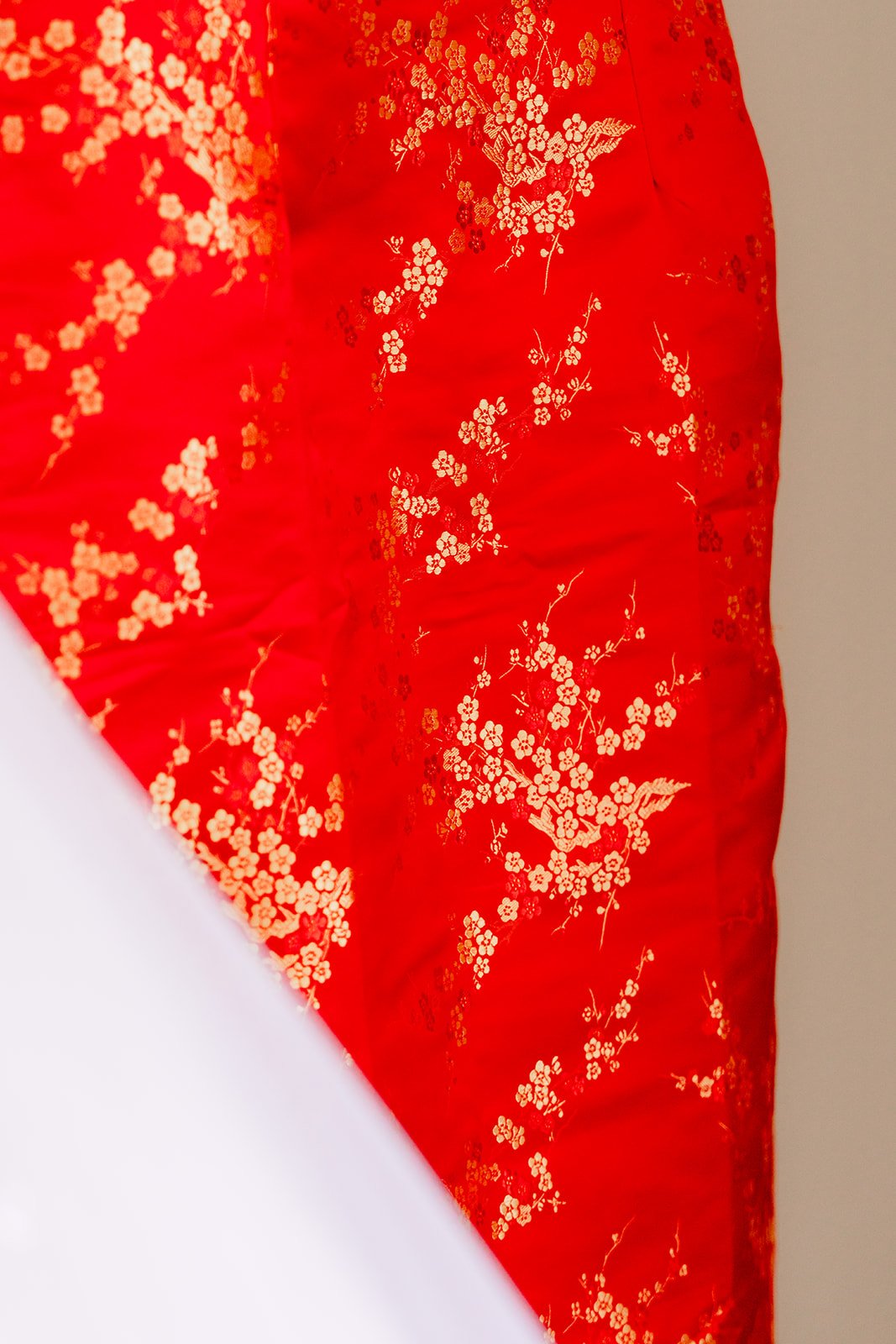 Close up of red and gold lace among Sandra's wedding details.